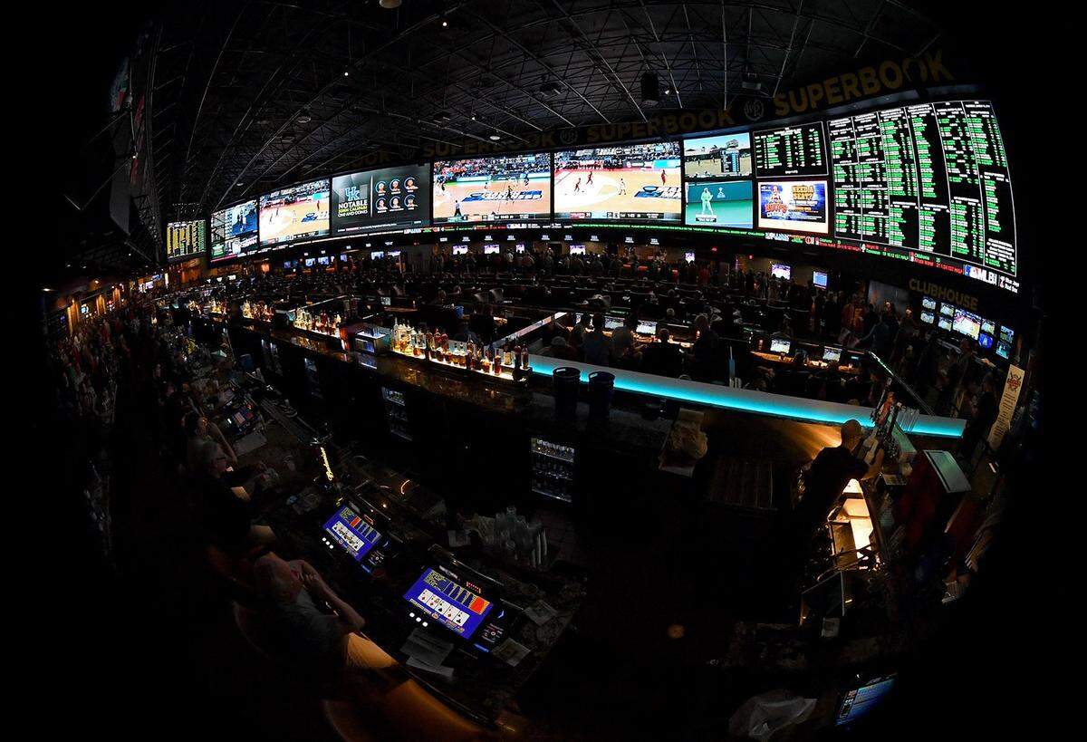 Guests attend a viewing party for the NCAA men’s basketball tournament inside the 25,000-square-foot Race & Sports SuperBook facility at the Westgate Las Vegas Resort & Casino in Las Vegas on March 15, 2018. “There will be a place for brick and mortar for UK basketball games and NFL football games (at Red Mile),” said Jim Goodman, director of wagering development at Keeneland.