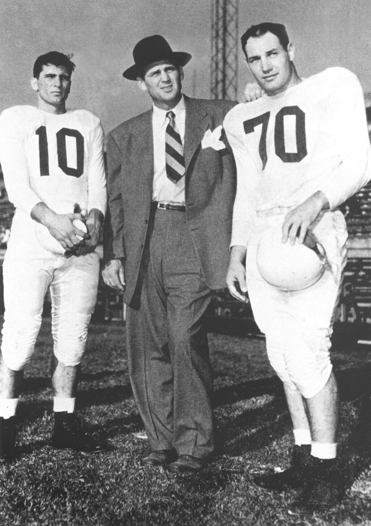 Kentucky football quarterback Babe Parilli (10), Coach Paul “Bear” Bryant and All-America tackle Bob Gain (70) were the pillars of the greatest era of Wildcats’ football.