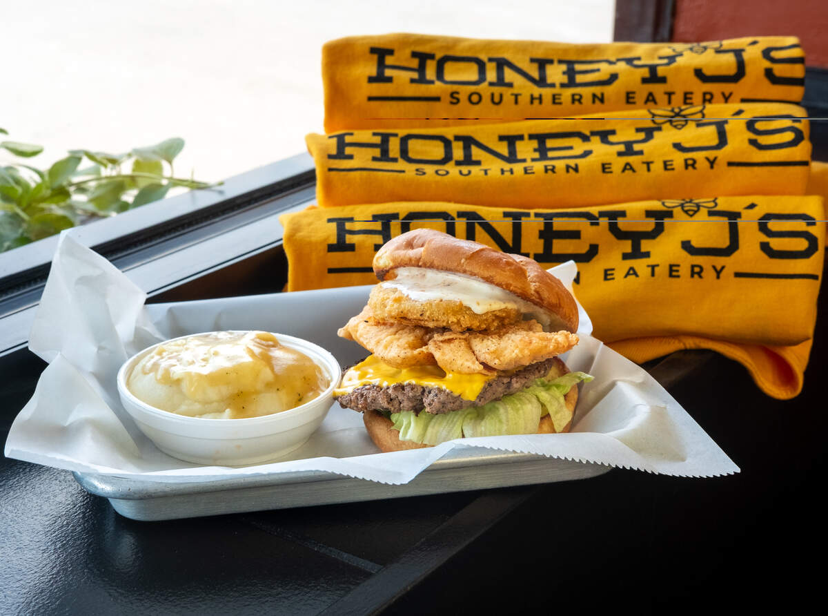 Southern Fried Chicken Stacker from Honey J’s, topped with fried green tomato, American cheese, fried chicken, cajun ranch and iceberg lettuce.