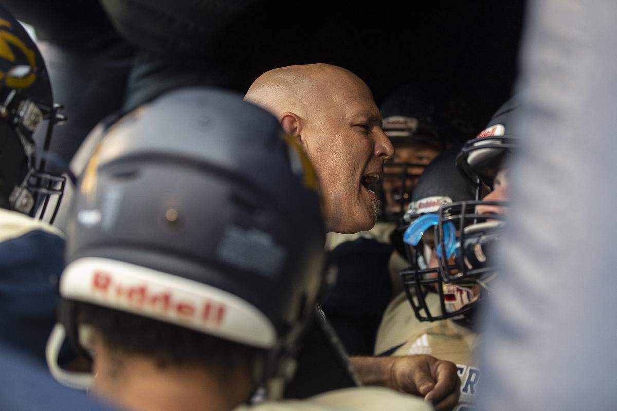 Knox Central assistant coach Jarrod Hargraves talks to the team before kickoff.