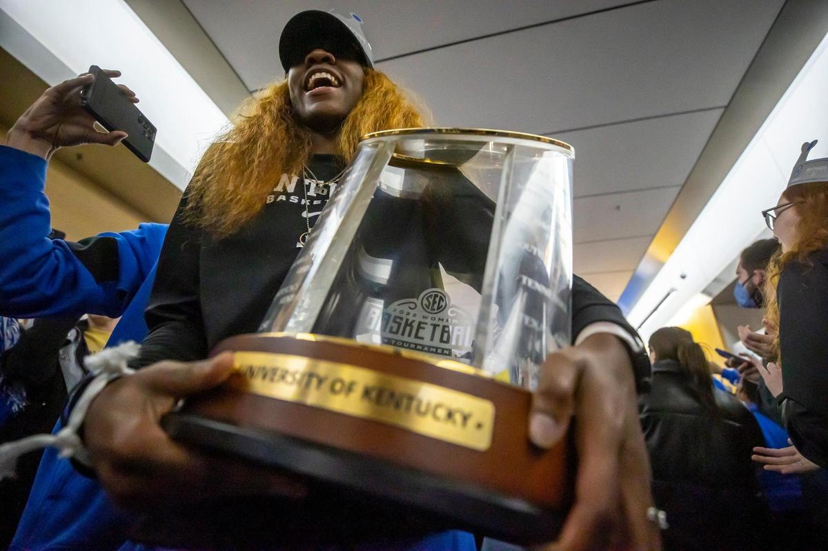 University of Kentucky women’s basketball player Rhyne Howard carries the SEC Tournament trophy as the team arrives at the Joe Craft Center on the UK campus in Lexington, Ky., on Sunday, March 6, 2022, after winning the Southeastern Conference Tournament for the first time in 40 years. The unranked Wildcats defeated the No. 1 Gamecocks, 64-62 on a three-pointer by Dre’una Edwards.