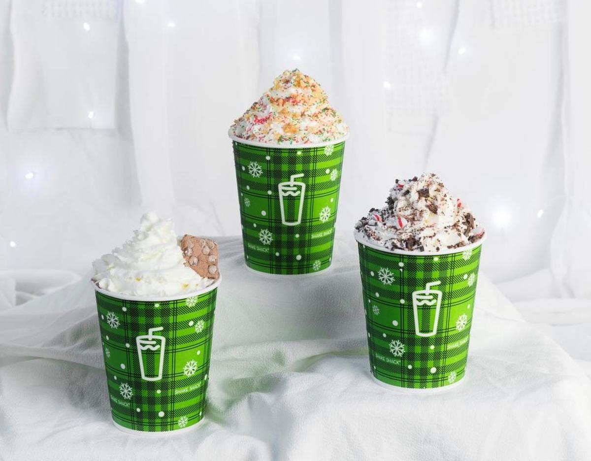From left: Frozen Hot Cocoa Shake with hot chocolate frozen custard topped with whipped cream and a chocolate chip marshmallow; Chocolate Peppermint Shake with chocolate frozen custard blended with peppermint and topped with whipped cream and chocolate peppermint candy crumble; and Christmas Cookie Shake with sugar cookie frozen custard topped with whipped cream, crumbled shortbread and red and green sprinkles. At Shake Shack through Jan. 1.