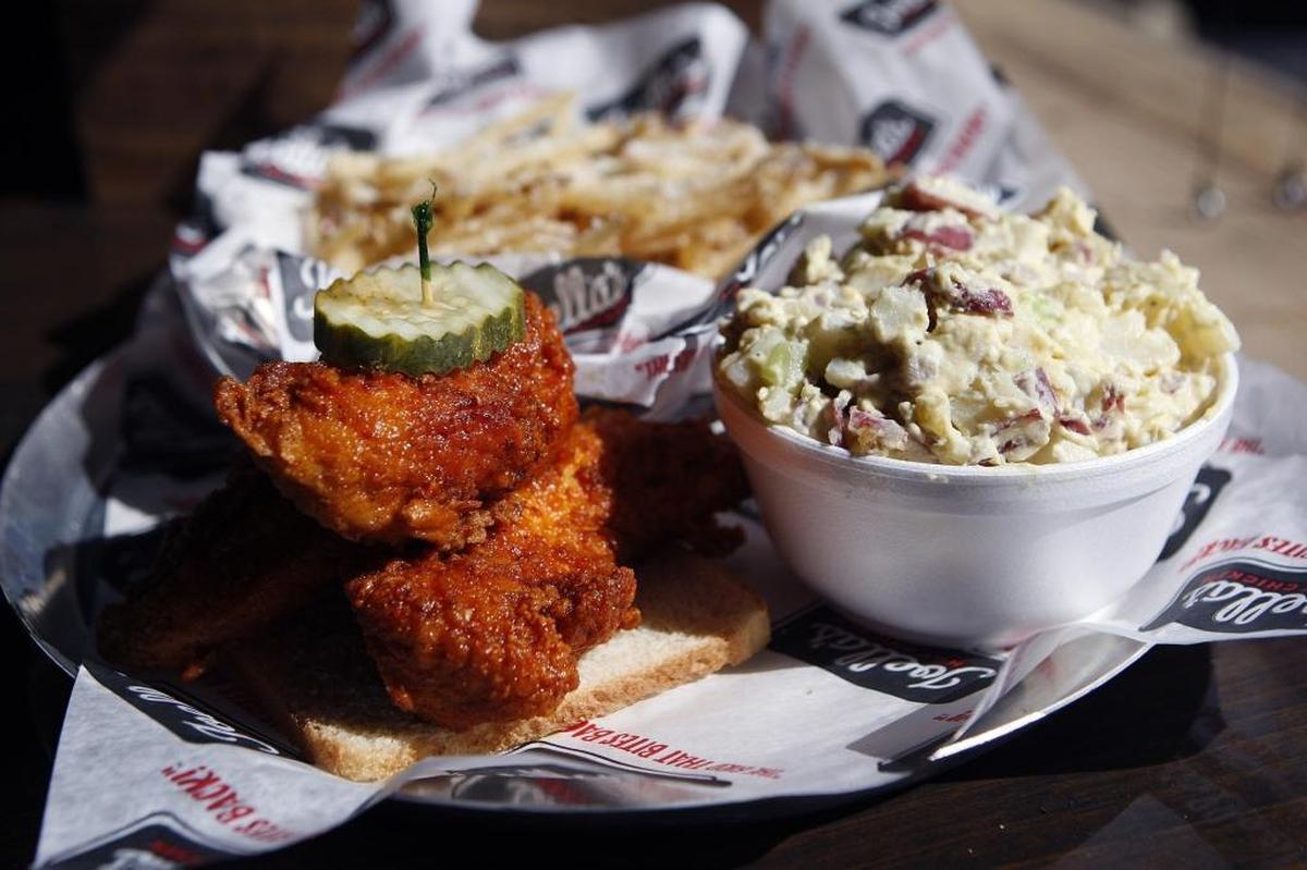 Chicken tenders with potato salad and garlic Parmesan fries at Joella’s Hot Chicken. Joella’s is known for letting customers choose the level of heat they want, from plain fried chicken to “Fire in Da Hole” hot.