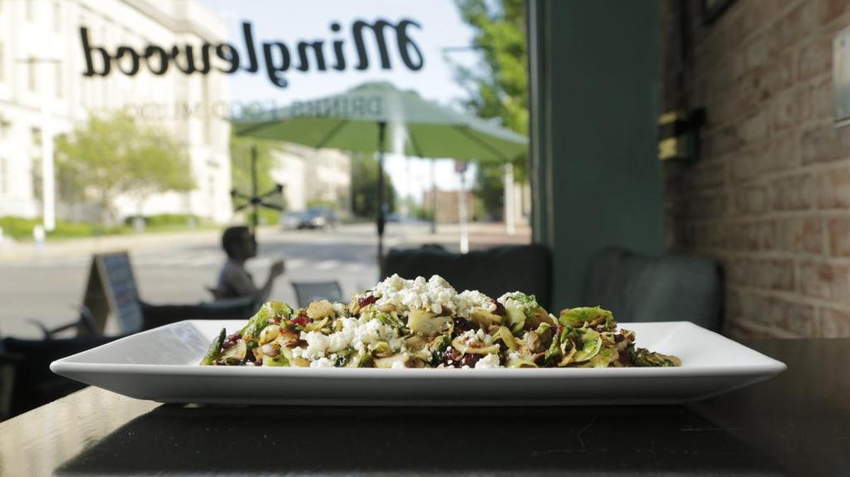 The warm Brussels sprout salad at Minglewood has roasted sprouts, cranberries, toasted pumpkin seeds, warm bacon vinaigrette, and bleu cheese crumbles.