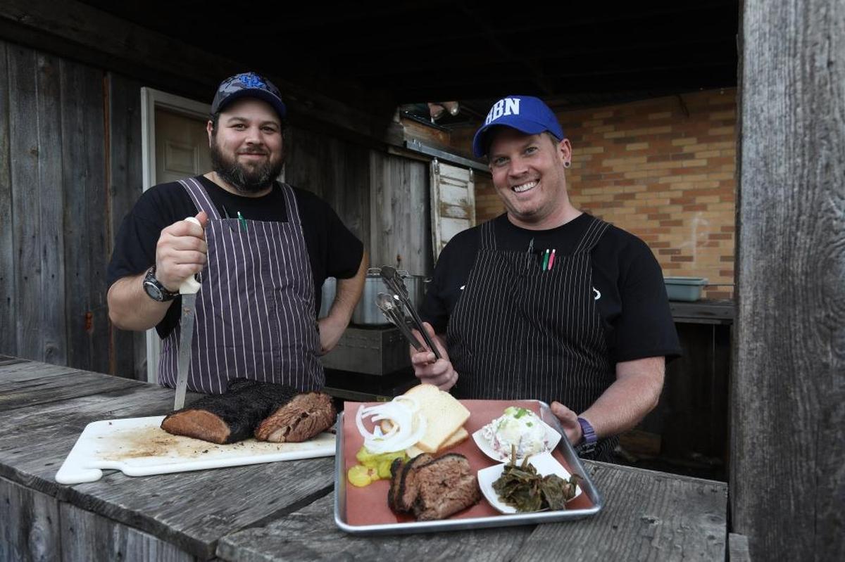 Blue Door Smokehouse co-owners Jeff Newman and Jon Rigsby, with brisket and platter.