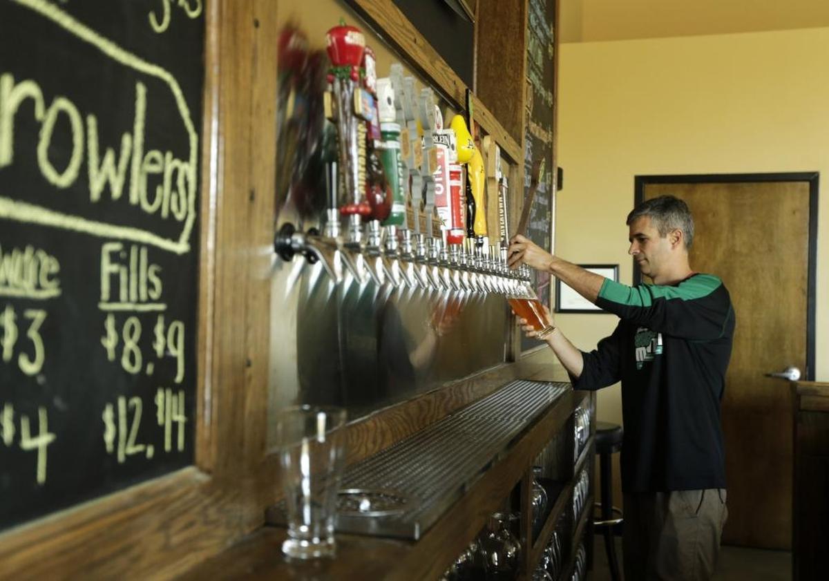 Owner Kevin Compton poured a beer for a customer at Pivot Brewing Company on Delaware Avenue in Lexington in 2016.
