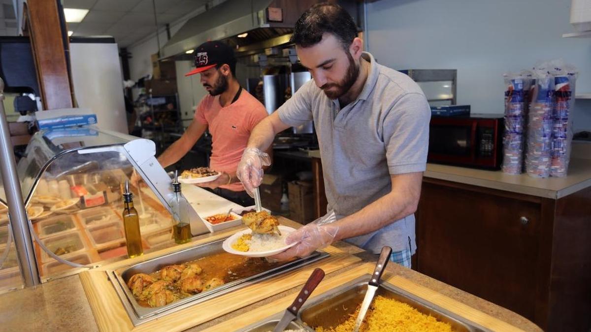 Hayder Zaidan prepared a spicy chicken sandwich dish at Nefertiti in the Eastland Shopping Center.