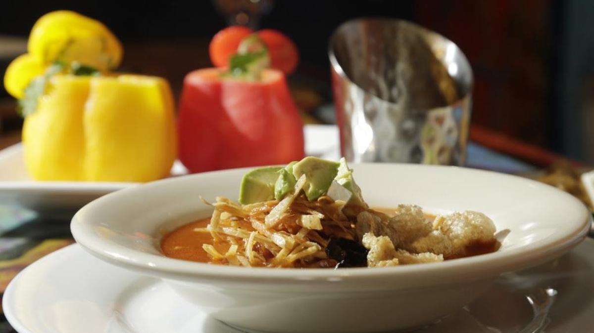 Sopa Azteca, or Aztec soup poured over ingredients at the table at Buenos Nachos, a new restaurant in the former Rincon Mexicano spot above Charlie Brown’s on Euclid.
