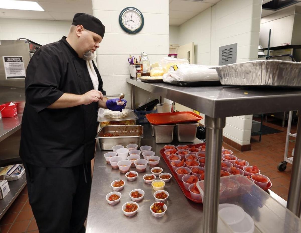 Chef James Hamilton made fresh black bean and corn salsa during lunch. Hamilton has devised menus, with the help of kid tasters, that have helped boost sales of lunch by 38 percent this year.