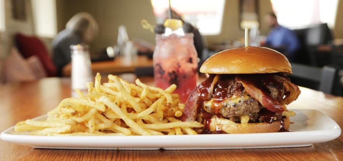 The bourbon bacon jam burger with fries, a popular option at Napa Prime in Versailles.