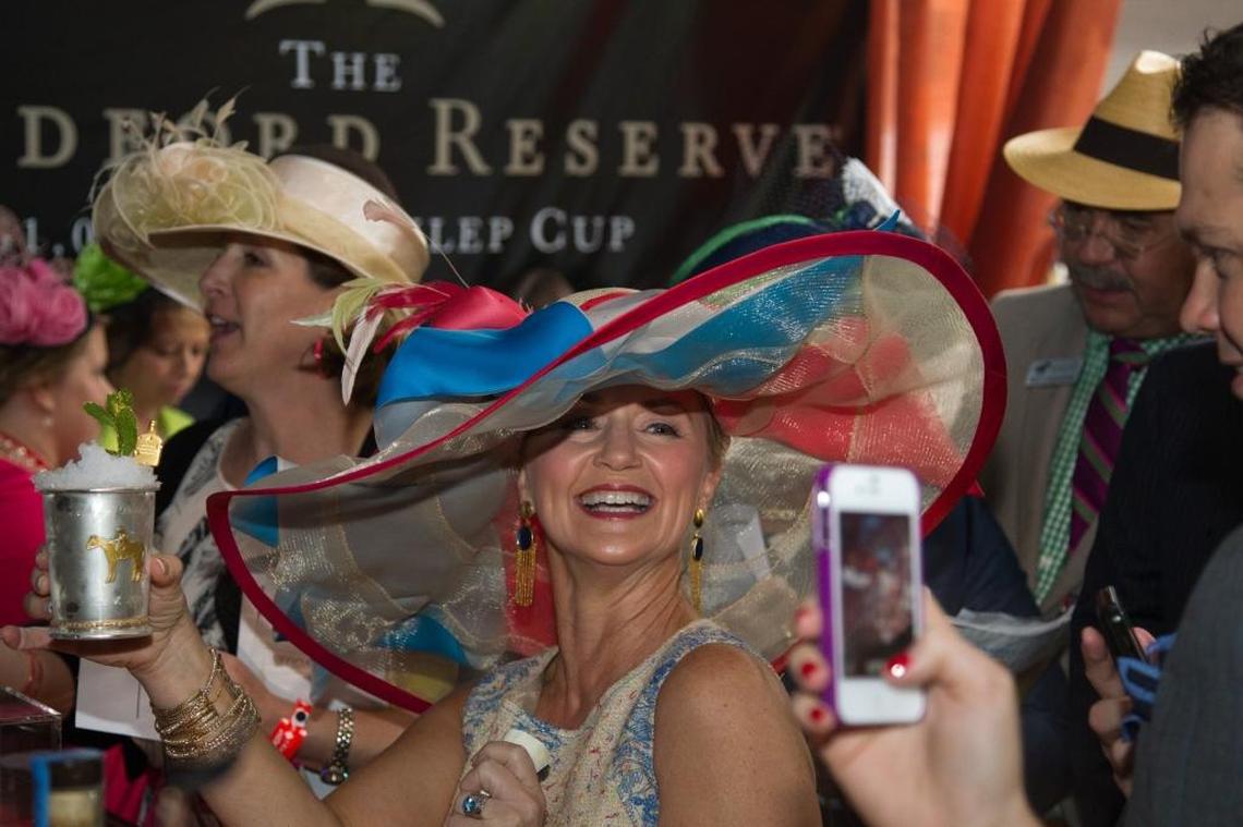Anita Cauley shows off her $1,000 mint julep in the Brown Forman tent before the 2013 Kentucky Derby. Note: You don’t have to have a $1,000 mint julep to have a complete Derby experience. Vendors are selling them for a fraction of that price all over Churchill Downs.
