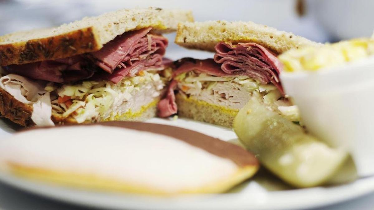 TAI on Rye offers several specialty sandwiches, including one with pastrami, turkey, homemade cole slaw and mustard. Each sandwich comes with a pickle and a side.