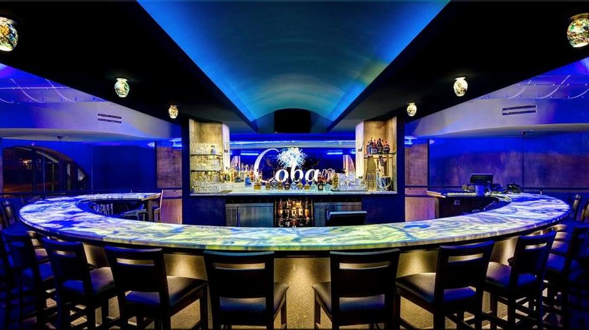 The upstairs bar, with its neon blue lights and marble accents, as well as blown-glass light fixtures, will be a bar with a slightly smaller menu, said Edson Munekata of Cowboy Brazilian Steakhouse. "We want to do Brazilian steakhouse tapas menu, for lack of a better word," he said. "Small portions of our meat with sides and everything else. So if a person doesn’t want the whole meal, just a light snack, they can come by, hang at the bar and watch the game, and have a little bit of what we do downstairs."