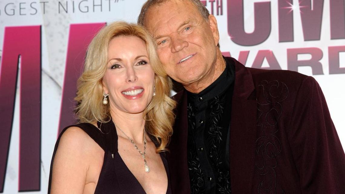 In this Nov. 9, 2011 file photo, Glen Campbell, right, and his wife Kim pose backstage at the 45th Annual CMA Awards in Nashville, Tenn.