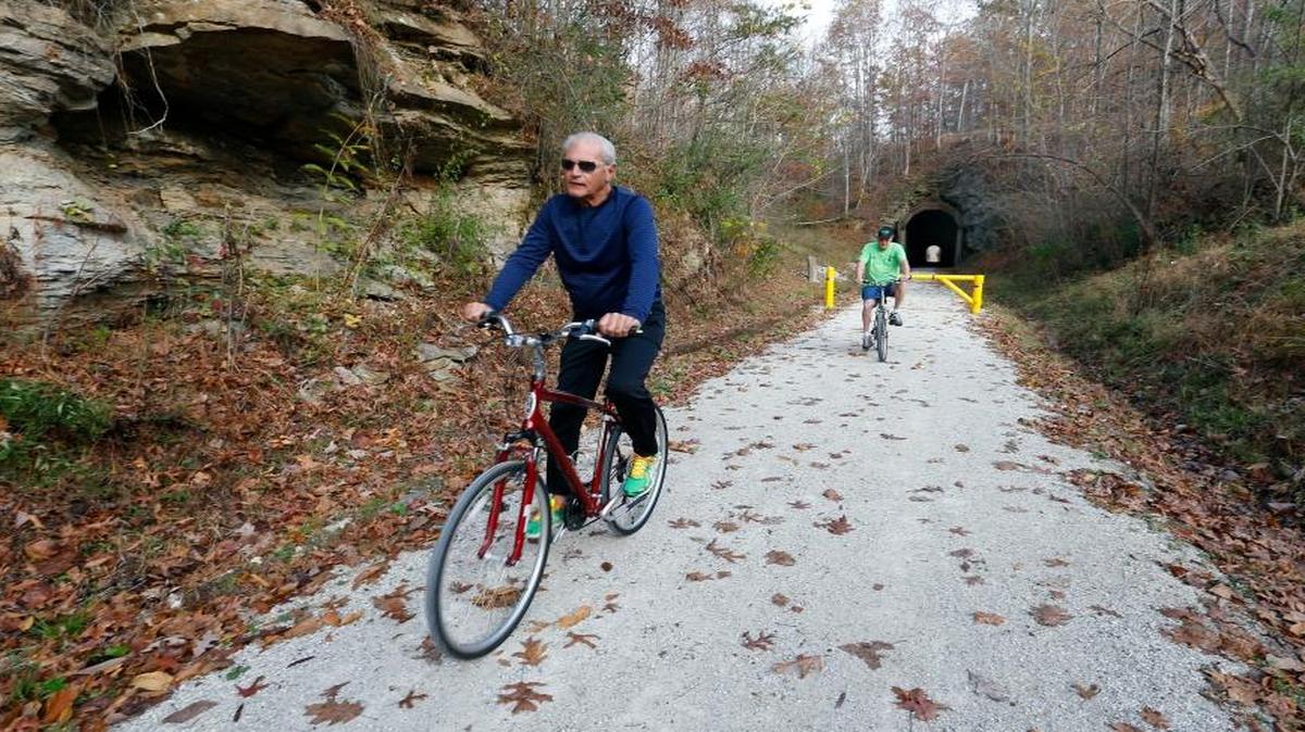 Dan Doucette, left, and Paul Bailey rode bikes on the Dawkins Line Rail Trail near Royalton in 2016. The trail in Magoffin County is 20 miles long.