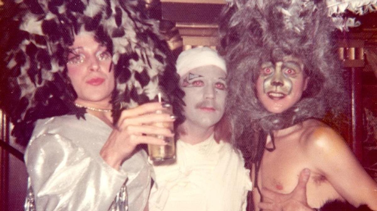 Three revelers, including Rick Milam, left, and Robert Morgan, right, posed for a photo inside the Living Room around 1970.