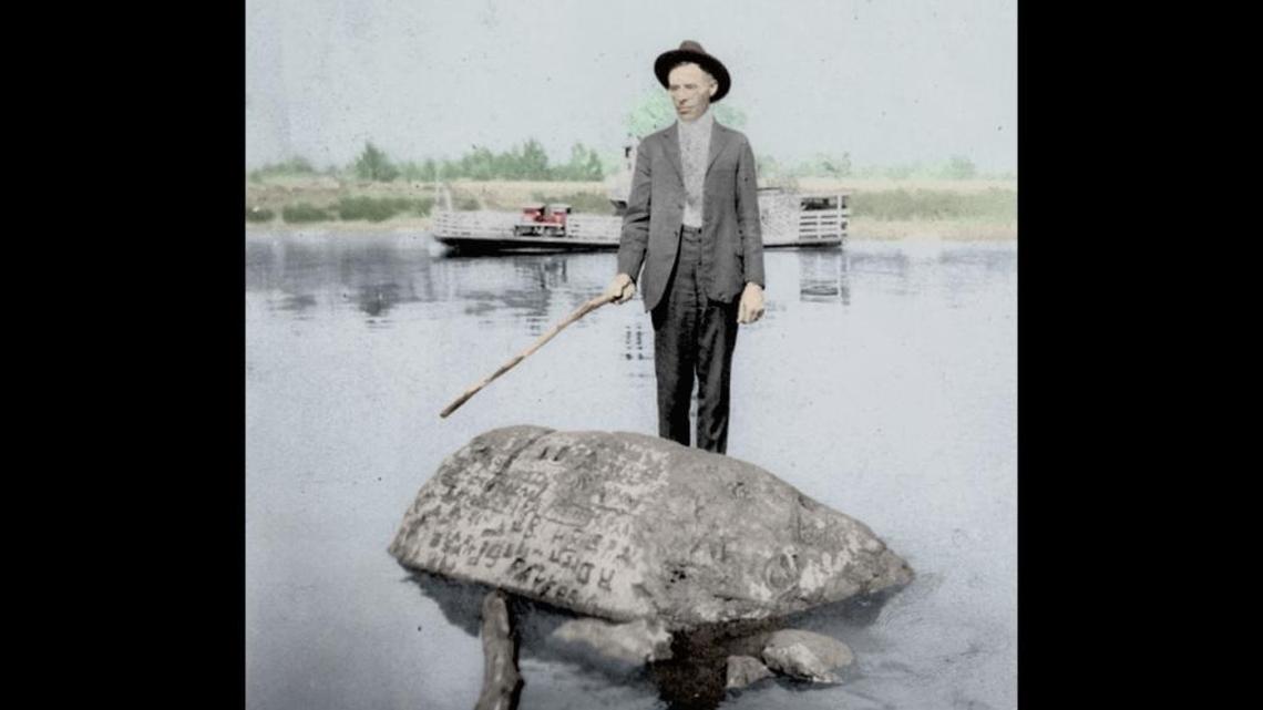 An unidentified man stands on Indian Head Rock on the Ohio River in the early 20th century, when the rock was a popular destination for photos.