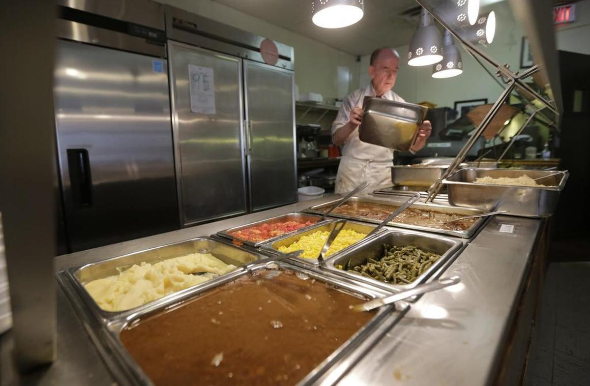 Liver and mashed potatoes were among the buffet options as Max Flannery swapped out an empty food tray in this 2016 photo.