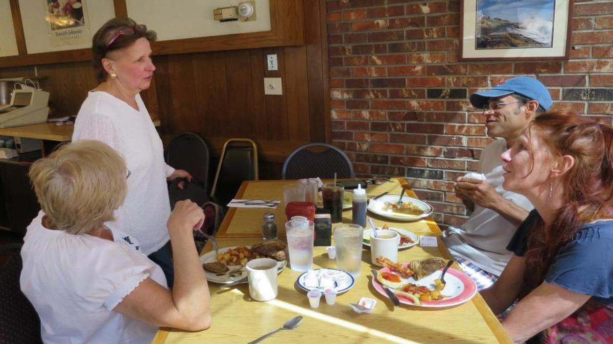Kathe Jewett, 68, a waitress at Howard Johnson’s in Bangor, Maine since it opened in 1966, spoke to customers Brenda Astbury, left, Christopher Leek and Kelly Gill. One of the last two Howard Johnson restaurants will close Sept. 6, taking with it the fried clam strips, ice cream and a slice of roadside Americana.