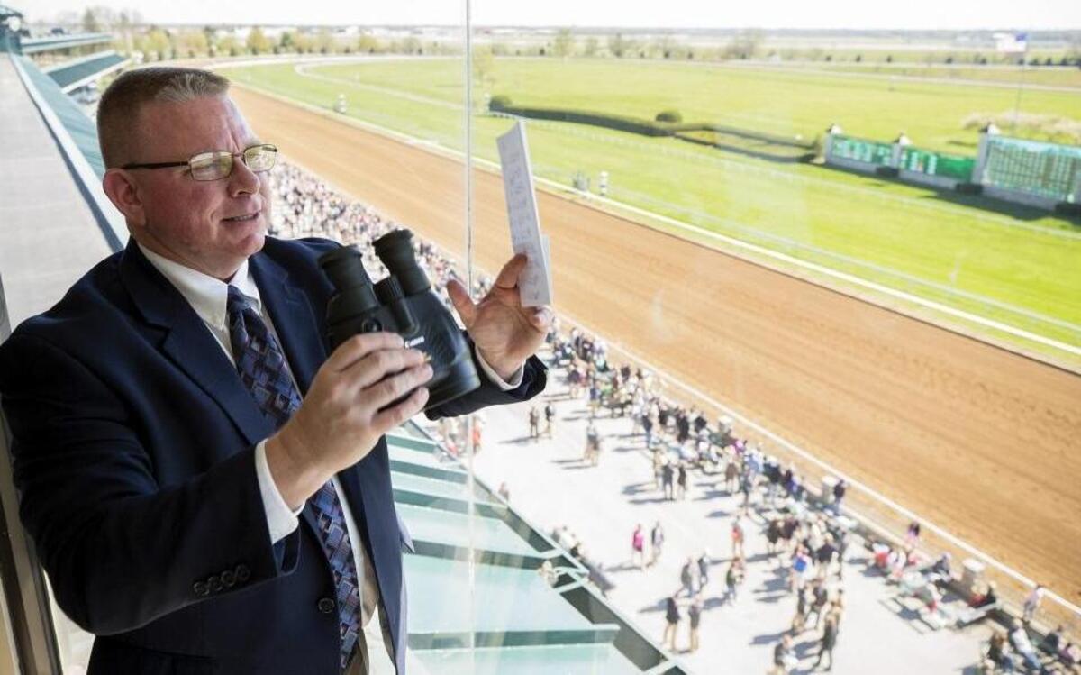 Kurt Becker, of Altamont, Ill., spotted horses before the seventh race during opening day at Keeneland in Lexington.