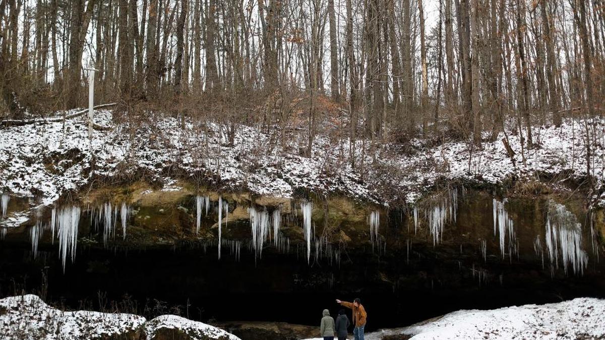 Tom Craig, right, a 20-year resident, took two AmeriCorps members on a tour of the Robertson Cave, a tourist attraction that was once home to clandestine meetings for early labor union organizers in the late 1800s in New Straitsville, Ohio.