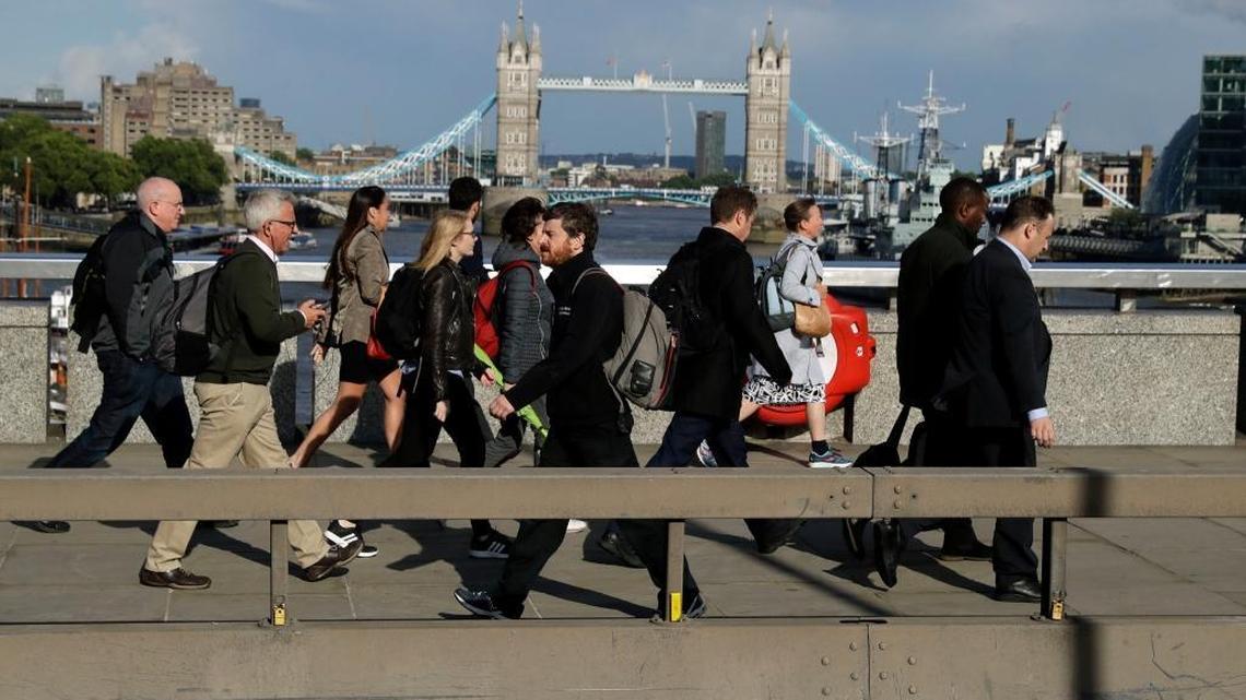 Commuters walked across London Bridge, with new security barriers, after work Tuesday. Londoners have a long history of enduring, dating to its founding more than 2,000 years ago.