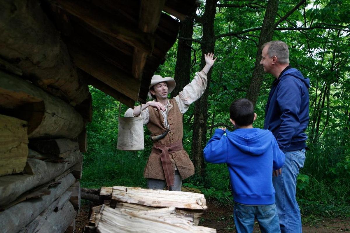 Tom Perry, left, chats with John Collins and his son Omid during Founders' Day, commemorating the founding of Lexington in 1775, at McConnell Springs in Lexington, in 2016.