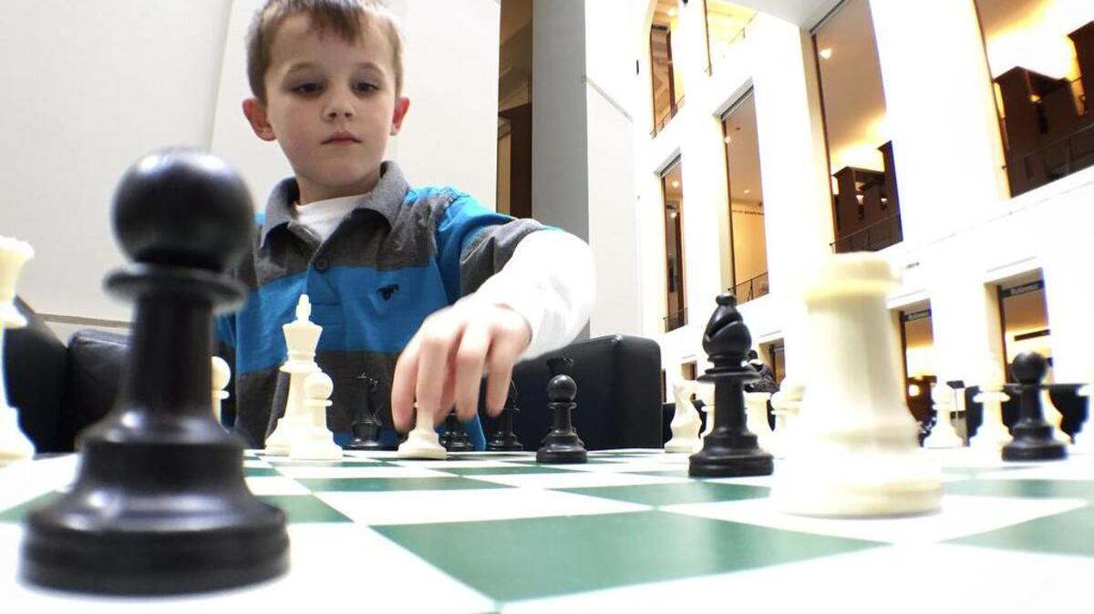 Five-year-old Caleb Marshall played some chess with some UK students in the W.T. Young Library in April.