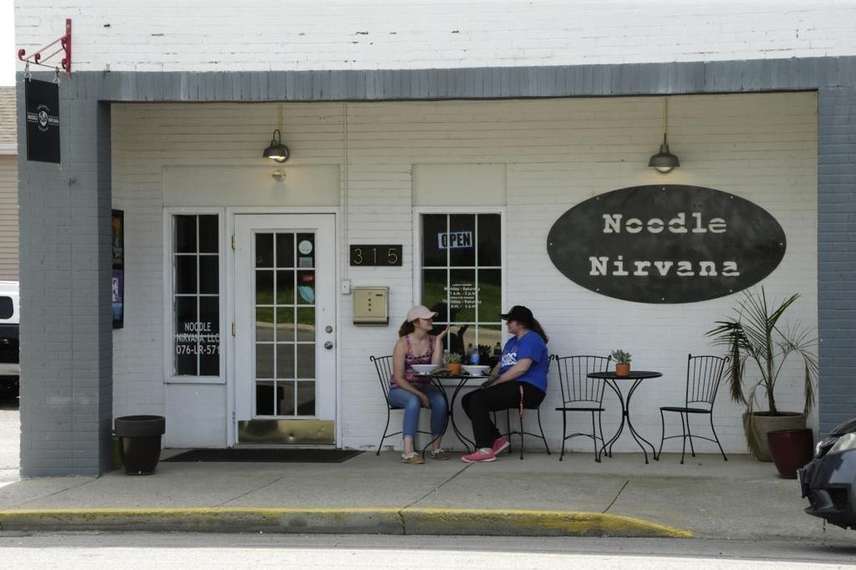 Haley Denney, left, and Brittany LaBelle ate their noodles in the outdoor seating area at Noodle Nirvana in 2017.