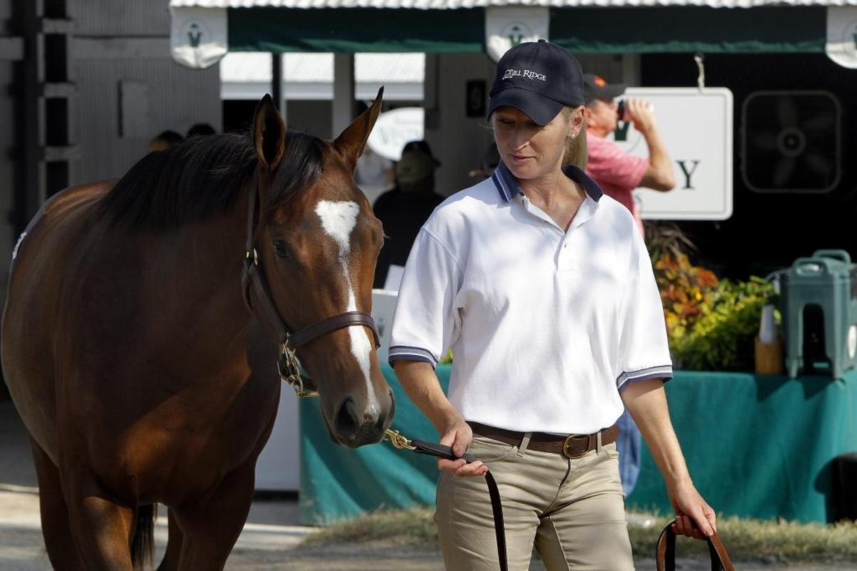 Patricia Akiona walks hip 3281, a yearling filly by Algorithms, at the Mill Ridge consignment in Barn 27 at the Keeneland September Yearling Sale.