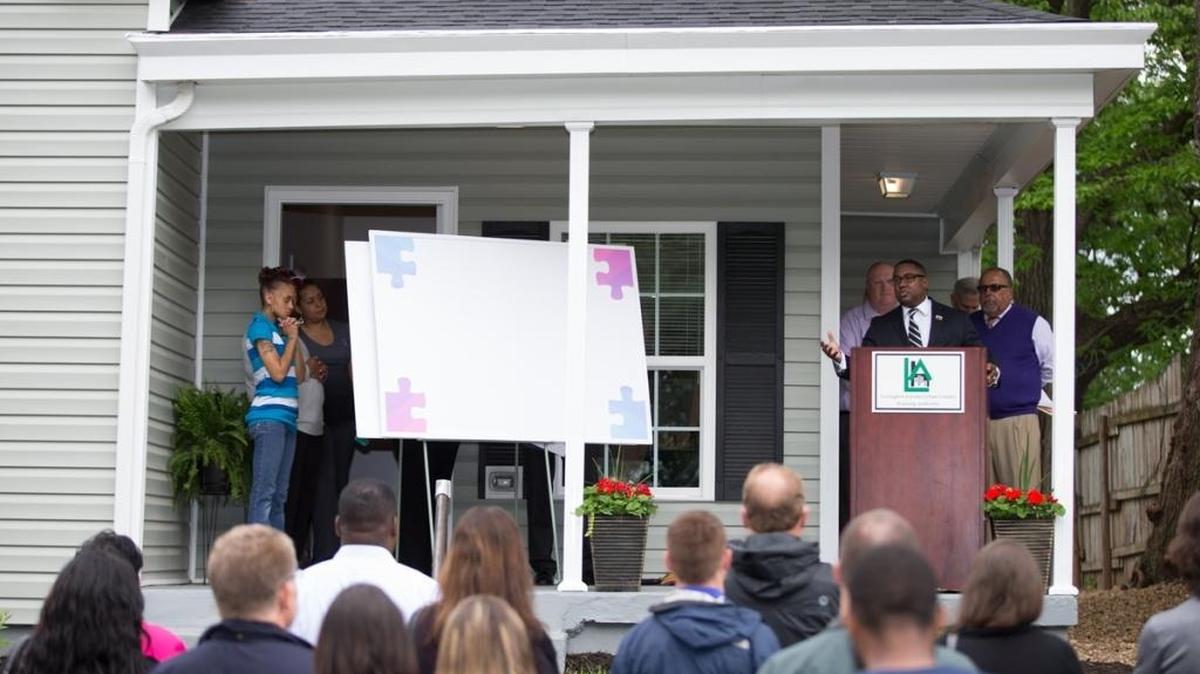 Malcom Ratchford, executive director of the Community Action Council addressed the crowd Monday at a house dedication. A public-private partnership renovated a house at 325 Wilgus Ave. The Lewis family, who had recently experienced homelessness, will love there.