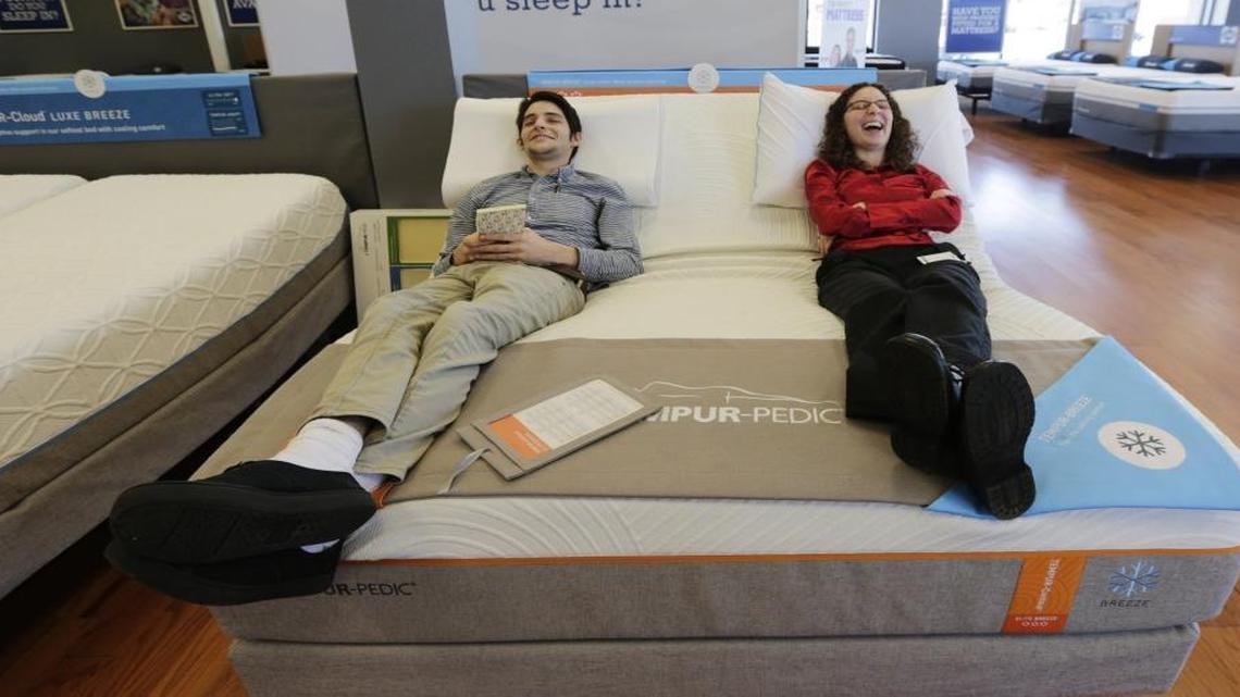 Preston Soper, left and Jacquine Vehmeier tried out a Tempur-Pedic mattress as part of their new employee orientation as customer service representatives at Sleep Outfitters on Nicholasville Road in Lexington. The Sleep Outfitters location now has a Mattress Firm competitor on the same corner of Nicholasville Road.
