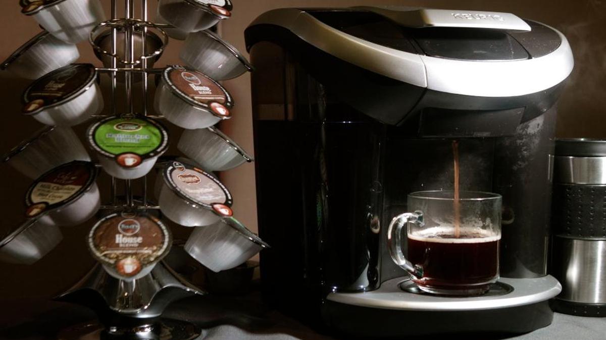 Keurig's Vue individual coffee roasting system is displayed during a Green Mountain Coffee Roasters news conference in 2012. The company plans by 2020 to change the plastic composition in the billions of K-cup single-serving coffee containers it sells.