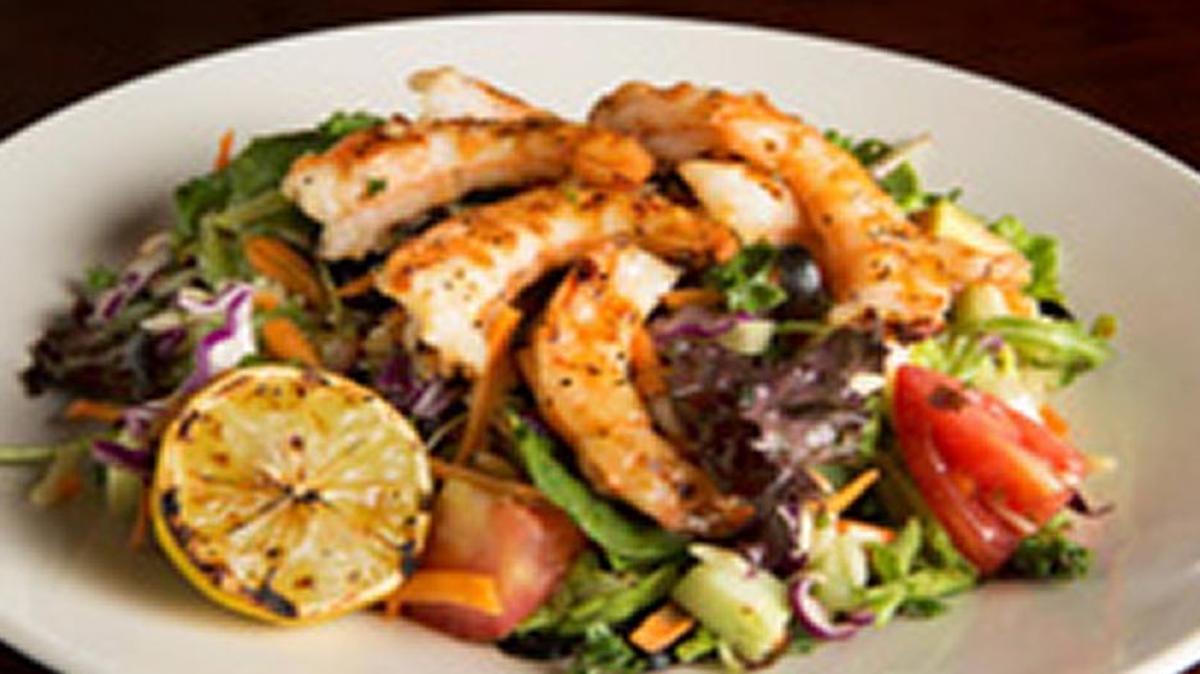 The shrimp orzo salad at Travinia featured mixed field greens with kale, tomatoes, black olives, carrots, cabbage, cucumbers, roasted garlic lemon vinaigrette.