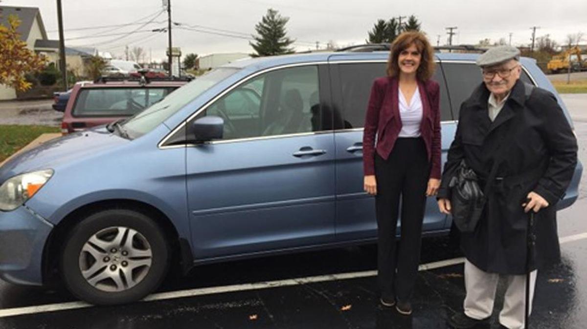 ITNBluegrass Executive Director Laura Dake stands with rider Jack Carty. Carty, 88, works five to six days a week and gets rides from ITNBluegrass to get there.