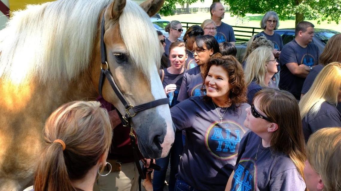 Jamie Puckett, center, and other teachers at Julius Marks Elementary School went to Walnut Hall Stock Farm on Aug. 8 to meet Mercy, a rescue Belgian draft horse that will be the ambassador for Take the Reins, a new service learning program at their school to teach children about the equine industry and benefit the Kentucky Equine Humane Center.