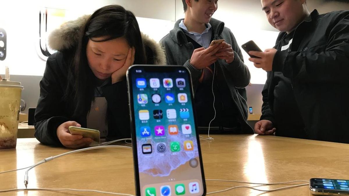 Mobile search surpassed desktop search in 2015. Small business owners can benefit from making the smartphone part of their marketing plan. In this photo, shoppers check out the iPhone X at an Apple store in Beijing, China, in 2017.