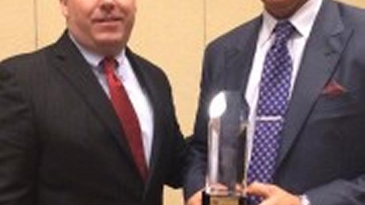 Bill Bell, left, highway safety specialist at the Kentucky Transportation Cabinet’s Office of Highway Safety, presented Lee Roberts of Roberts Heavy Duty Towing and Recovery with an award for outstanding highway safety efforts.