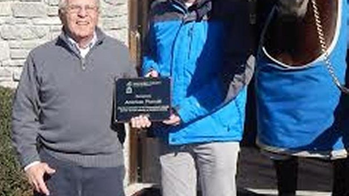 From left, Don Vizi, executive director of the Woodford County Chamber of Commerce, presented a plaque to American Pharaoh from the Chamber for his contributions to the horse industry and the tourism industry. Accepting the plaque for American Pharaoh were Scott Calder with Coolmore America/Ashford Stud and Michael Norris.
