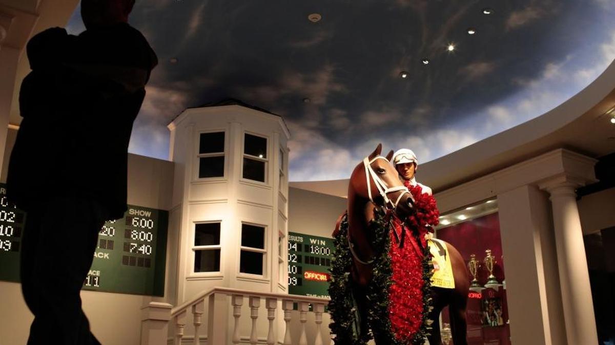 The Winners Circle at the Kentucky Derby Museum allows visitors to take their picture with a replica of the most recent Derby winner. The horse statue is painted to look like the winner and the jockey is dressed in replica silks. This room was flooded with over 2 inches of water in 2009. This 2010 file photo was taken after the museum had been renovated and the museum reopened.