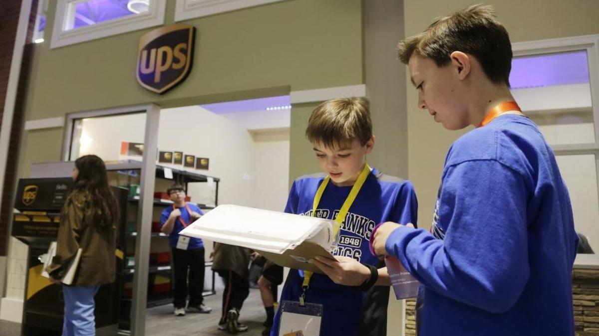 Chase Pace, left, a Kentucky Utilities worker and Trevor Morgan, who works at Kentucky Health worked on a survey during an Athens-Chilesburg Elementary School field trip to JA BizTown recently. Students assume roles in the Junior Achievement mock city and conduct business to learn financial responsibility.