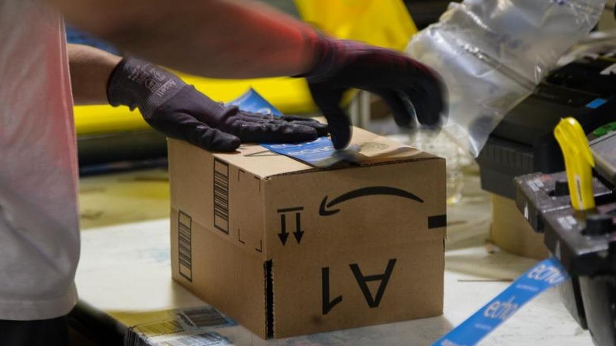 In this file photo, a worker tapes a box while packing items on Cyber Monday at the Amazon Fulfillment Center in San Bernardino, Calif. Amazon announced that it will increase its full-time workforce, adding 100,000 jobs, 1,000 in Kentucky, in the next 18 months.