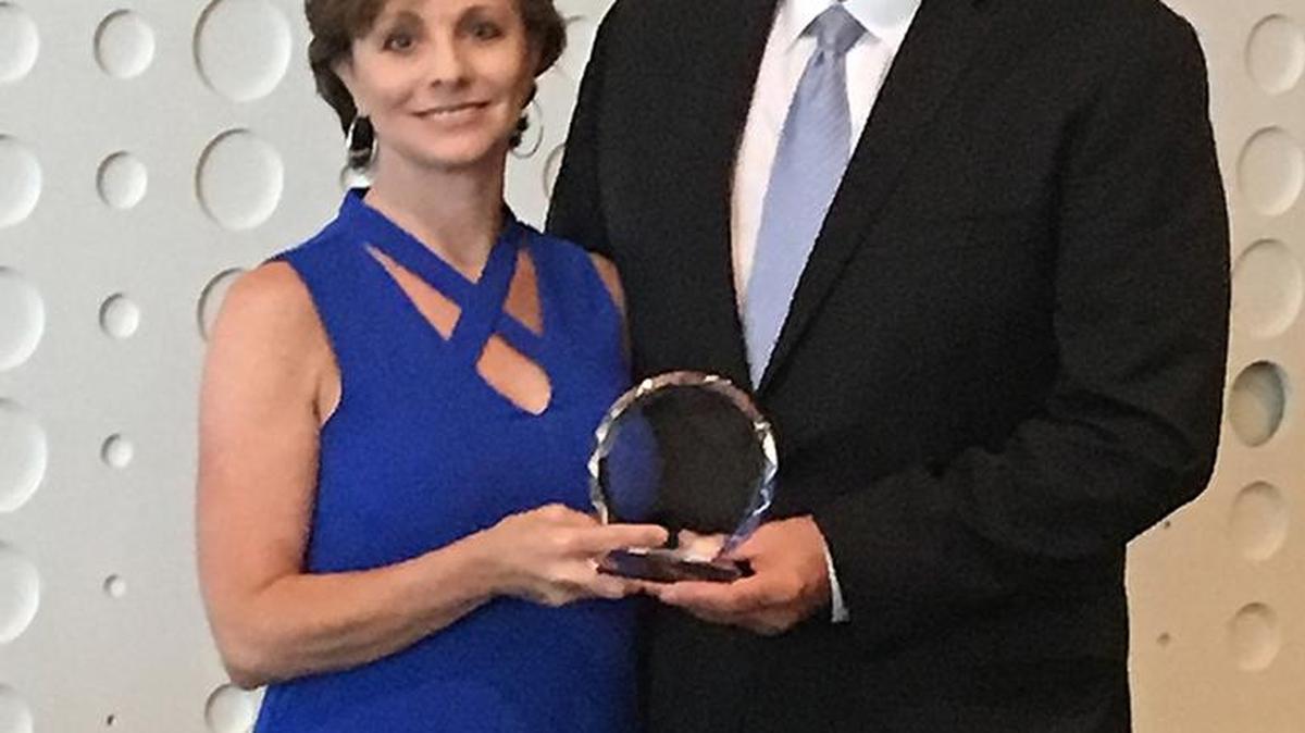 Kelly Bates, left, Commerce Lexington’s member engagement manager, was presented a Lifetime Sales Achievement Award from outgoing Association of Chamber of Commerce Executives President Mick Fleming.