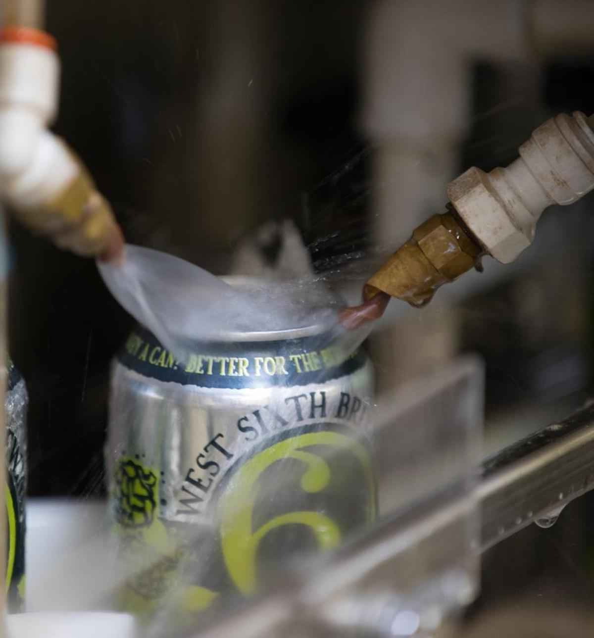 Cans were rinsed off after being filled at West 6th Brewery in Lexington.