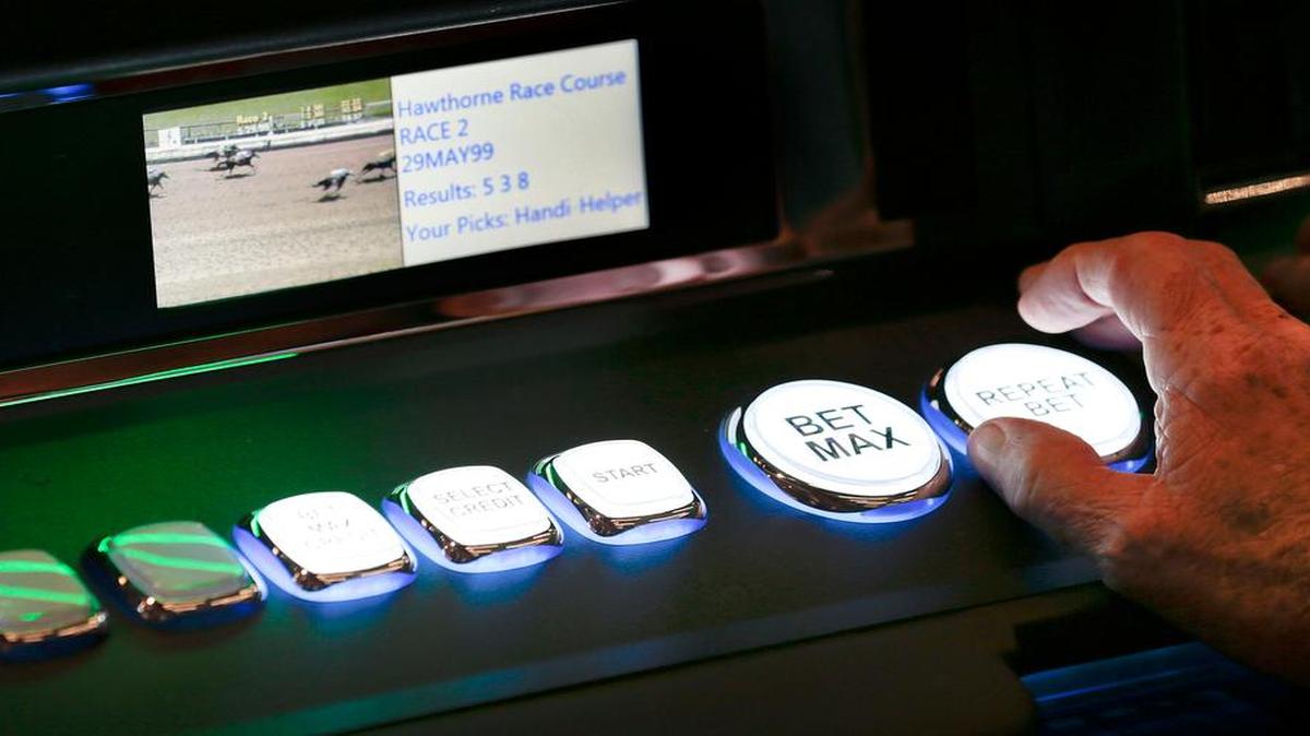 Following a ribbon-cutting ceremony at the Red Mile last year, Ken Upthegrove of Lexington played one of the 902 instant racing machines. Through the end of August, about $197 million had been wagered at the facility.