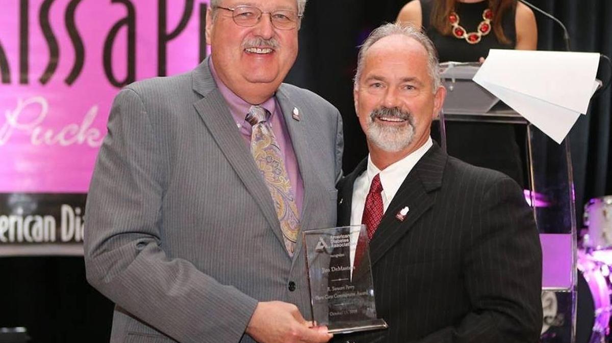 R. Stewart Perry, left, presented Jim DeMasters of Novo Nordisk with the R. Stewart Perry Cure Care Commitment Award from ADA Bluegrass.