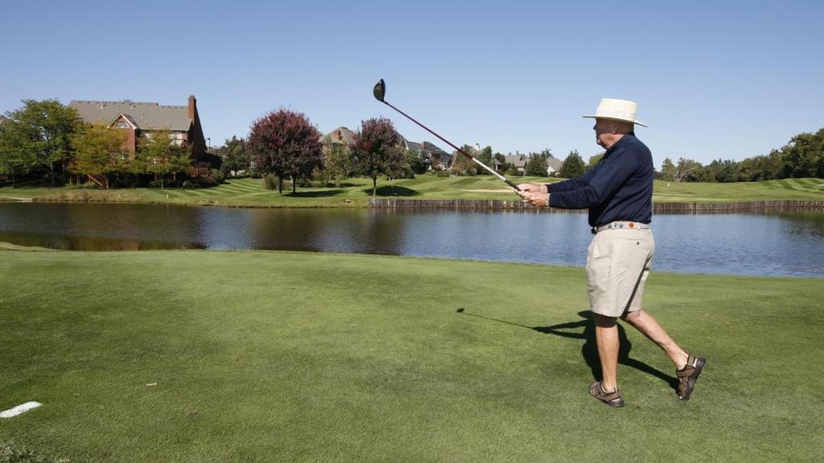 In this 2009 file photo, club member George Kirk teed off at the Andover Golf and Country Club, with the Andover Subdivision in the background. Photo by Charles Bertram | Staff