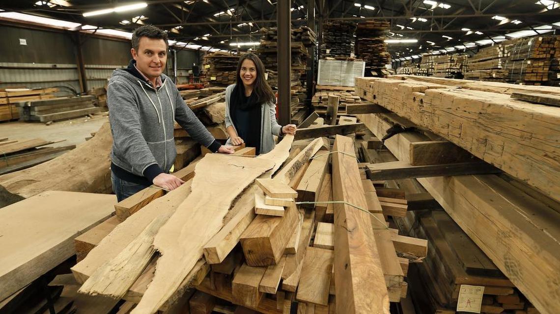 Nathan Brown, the founder, and his sister Liz Brown, senior sales executive, by some of their wood at Old World Timber, 1195 Versailles Road in Lexington.