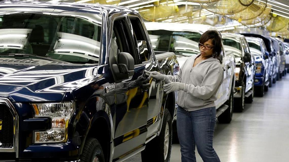 In this 2015, file photo, a worker inspects a new aluminum-alloy body Ford F-150 truck at the company's Kansas City Assembly Plant, in Claycomo, Mo.