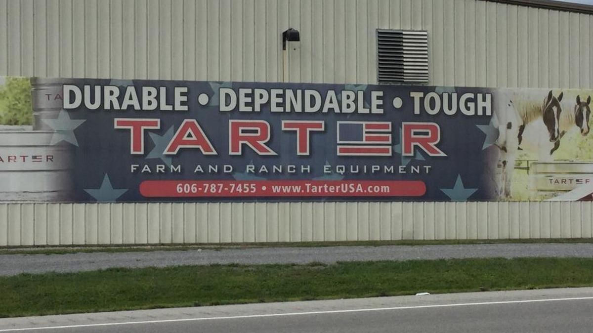 A sign on the side of Liberty Water Tanks advertises galvanized water tanks. The property between Liberty and Dunnville in Casey County is one of several in the Tarter family of companies.